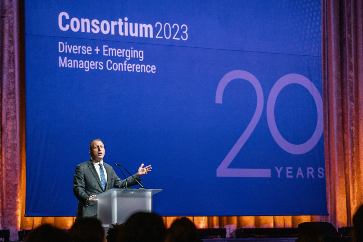 A man speaking on stage at Consortium 2023